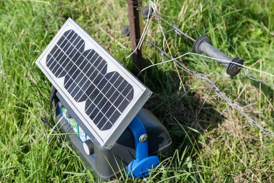 Solar panel in a field as power source for electric fence